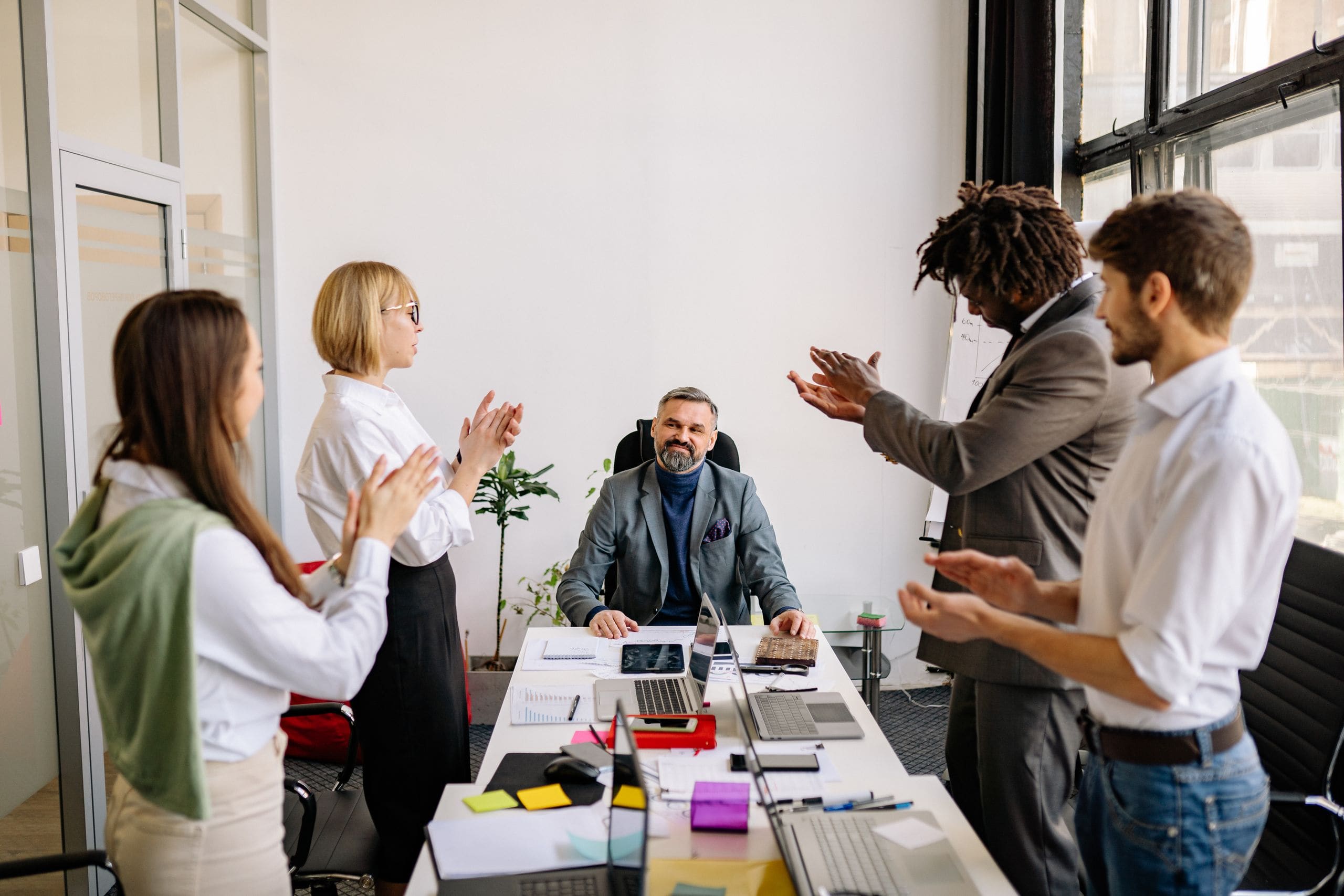 Colleagues applauding together in a bright Vancouver office
